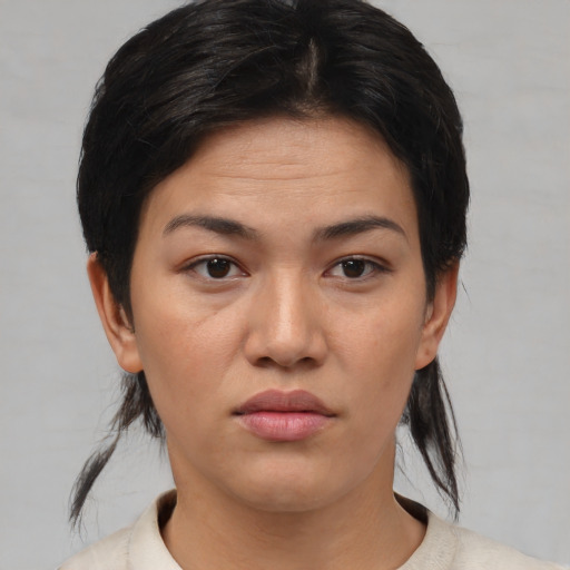 Joyful asian young-adult female with medium  brown hair and brown eyes
