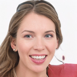 Joyful white young-adult female with long  brown hair and blue eyes