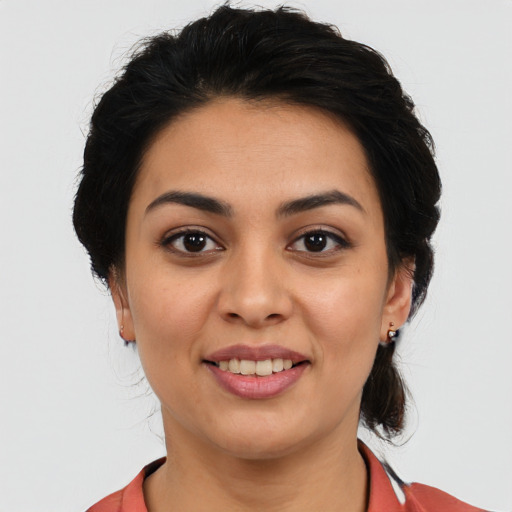 Joyful latino young-adult female with medium  black hair and brown eyes