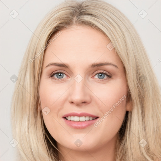 Joyful white young-adult female with long  brown hair and blue eyes