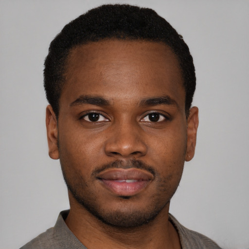 Joyful latino young-adult male with short  brown hair and brown eyes