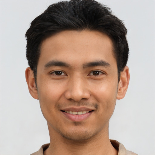 Joyful asian young-adult male with short  black hair and brown eyes