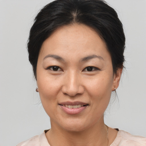 Joyful asian adult female with medium  brown hair and brown eyes