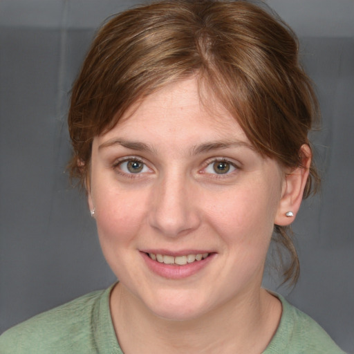 Joyful white young-adult female with medium  brown hair and grey eyes