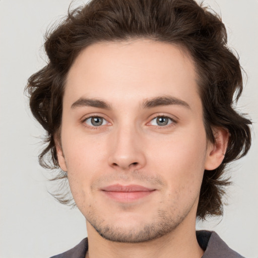 Joyful white young-adult male with medium  brown hair and brown eyes