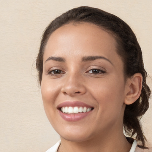 Joyful white young-adult female with medium  brown hair and brown eyes