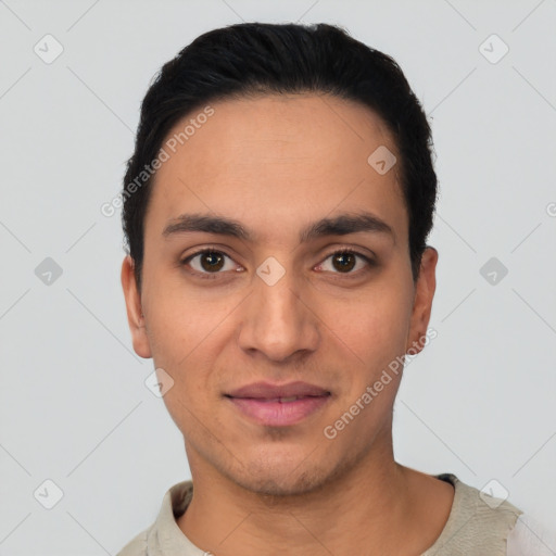 Joyful latino young-adult male with short  black hair and brown eyes