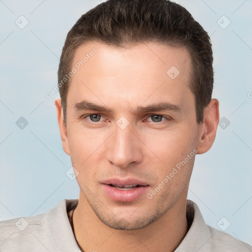 Joyful white young-adult male with short  brown hair and brown eyes