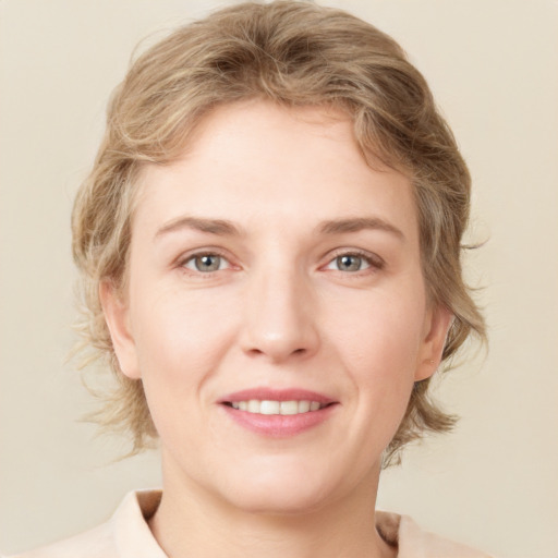 Joyful white young-adult female with medium  brown hair and green eyes