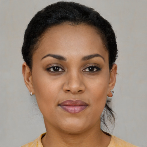 Joyful black young-adult female with short  brown hair and brown eyes
