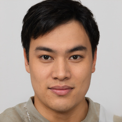 Joyful asian young-adult male with short  brown hair and brown eyes