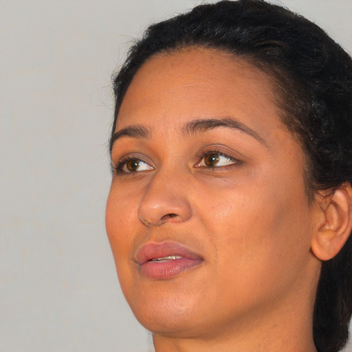 Joyful black young-adult female with medium  brown hair and brown eyes