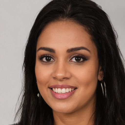 Joyful latino young-adult female with long  black hair and brown eyes