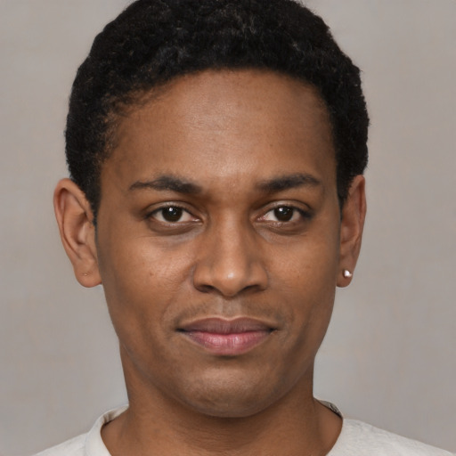 Joyful black young-adult male with short  brown hair and brown eyes