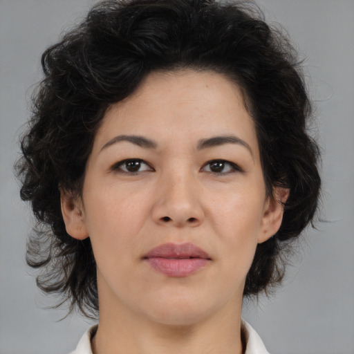 Joyful asian adult female with medium  brown hair and brown eyes