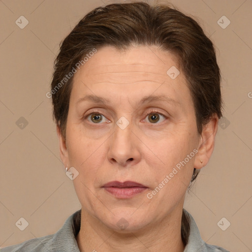 Joyful white adult female with medium  brown hair and grey eyes