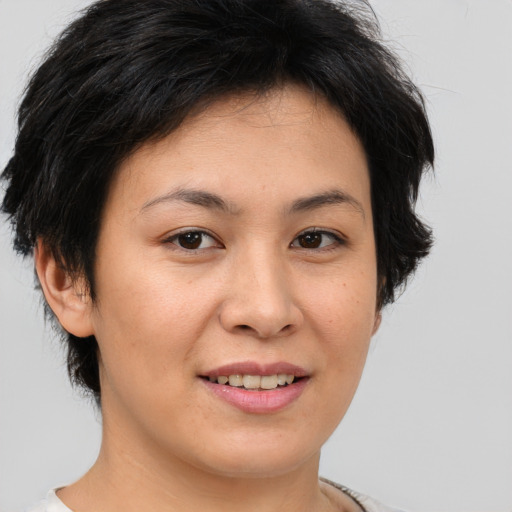 Joyful asian young-adult female with short  brown hair and brown eyes