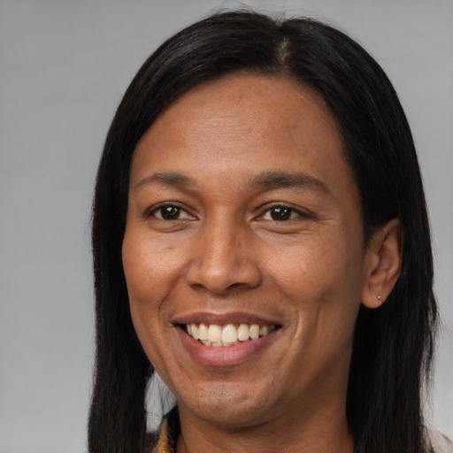 Joyful latino adult female with long  brown hair and brown eyes