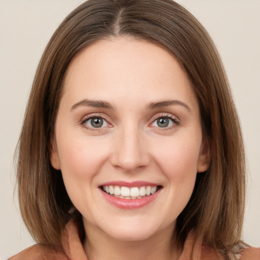 Joyful white young-adult female with medium  brown hair and green eyes