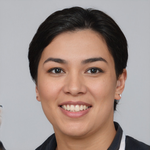 Joyful asian young-adult female with medium  brown hair and brown eyes
