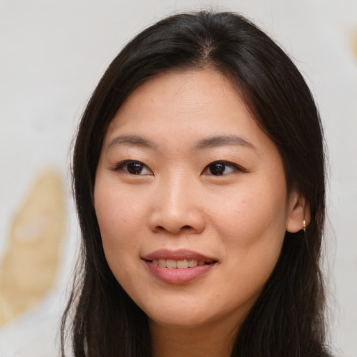 Joyful asian young-adult female with long  brown hair and brown eyes