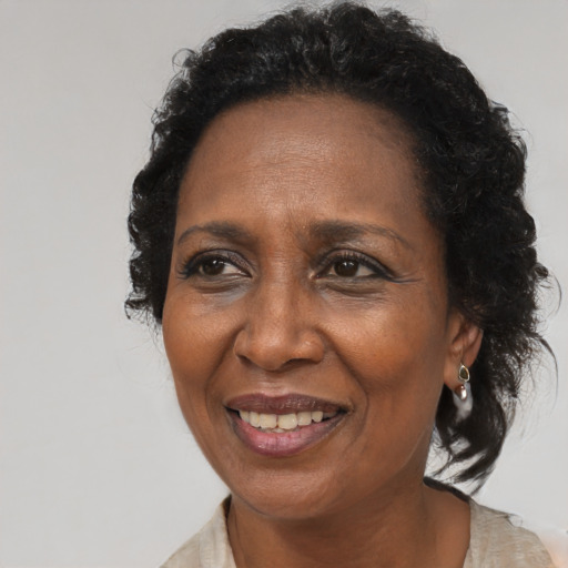 Joyful black adult female with medium  brown hair and brown eyes