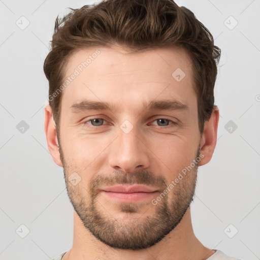 Joyful white young-adult male with short  brown hair and grey eyes