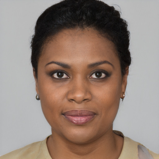 Joyful black young-adult female with short  brown hair and brown eyes