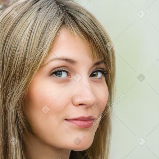 Joyful white young-adult female with long  brown hair and green eyes