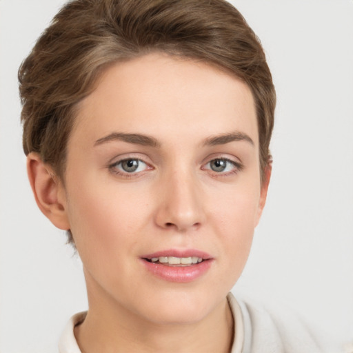 Joyful white young-adult female with short  brown hair and grey eyes