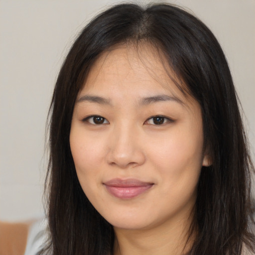 Joyful asian young-adult female with long  brown hair and brown eyes
