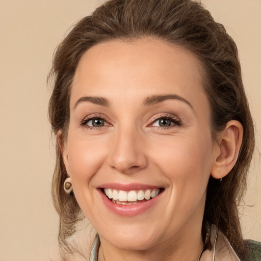 Joyful white young-adult female with medium  brown hair and green eyes