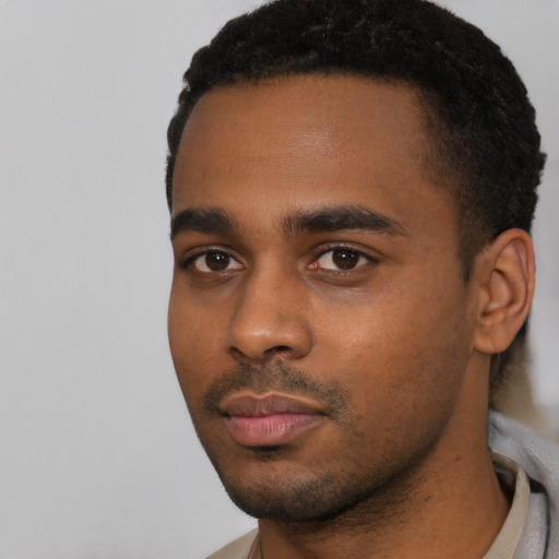 Neutral black young-adult male with short  black hair and brown eyes