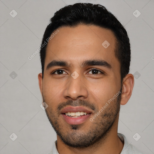 Joyful latino young-adult male with short  black hair and brown eyes