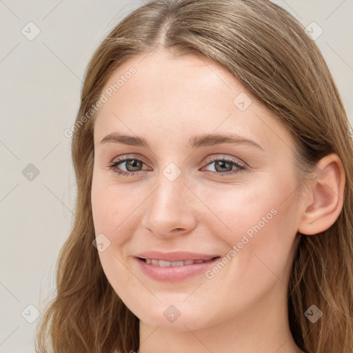 Joyful white young-adult female with long  brown hair and blue eyes