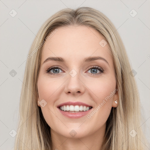 Joyful white young-adult female with long  brown hair and blue eyes