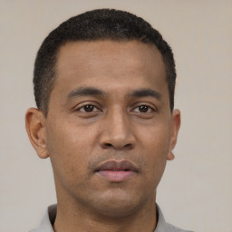 Neutral latino young-adult male with short  black hair and brown eyes
