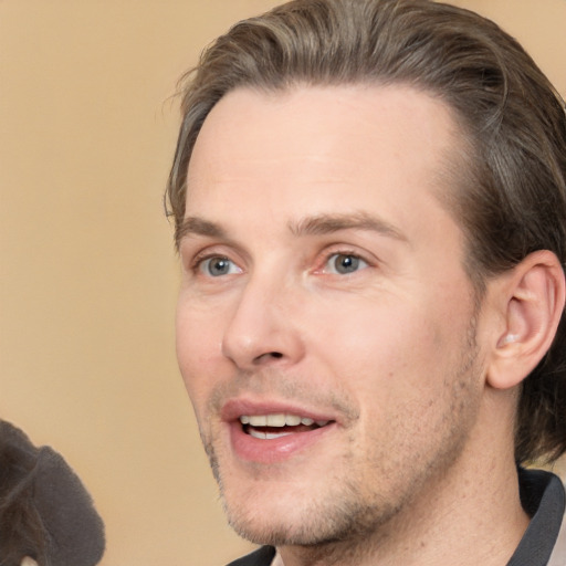 Joyful white adult male with short  brown hair and brown eyes