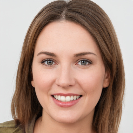 Joyful white young-adult female with long  brown hair and green eyes