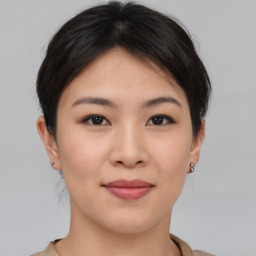 Joyful asian young-adult female with short  brown hair and brown eyes