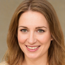 Joyful white young-adult female with long  brown hair and green eyes