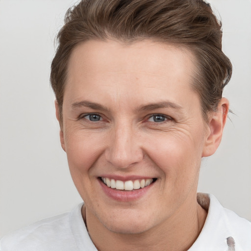 Joyful white adult female with short  brown hair and grey eyes