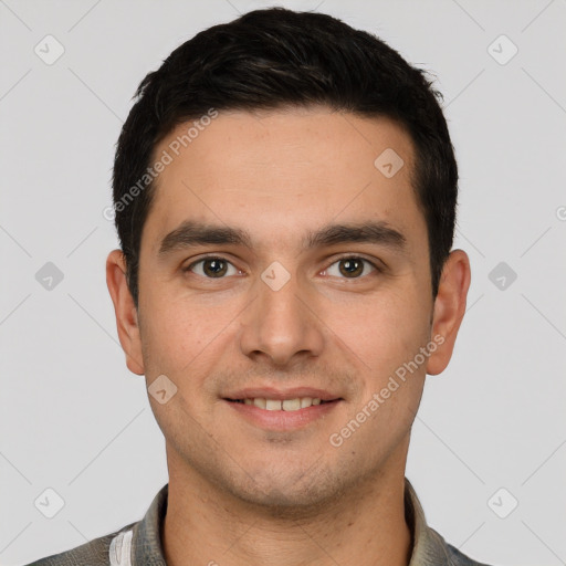 Joyful white young-adult male with short  black hair and brown eyes