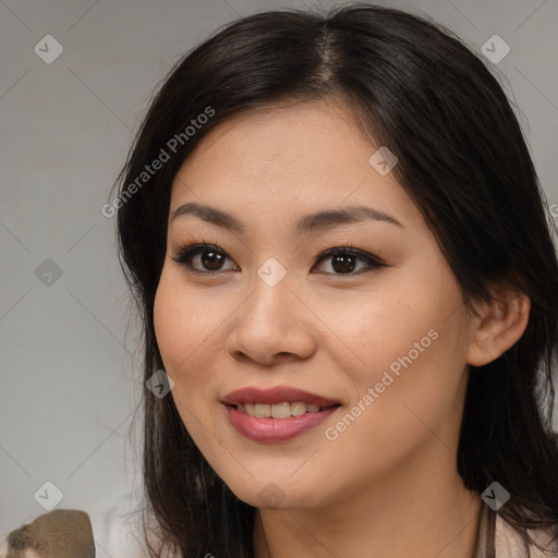 Joyful asian young-adult female with long  brown hair and brown eyes