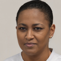 Joyful black young-adult female with short  black hair and brown eyes