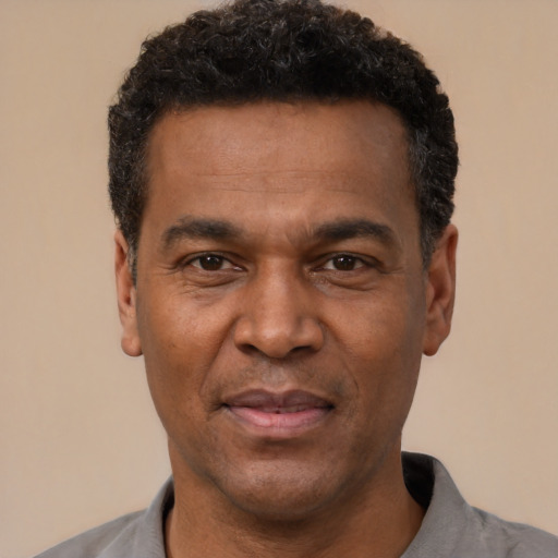 Joyful latino adult male with short  black hair and brown eyes