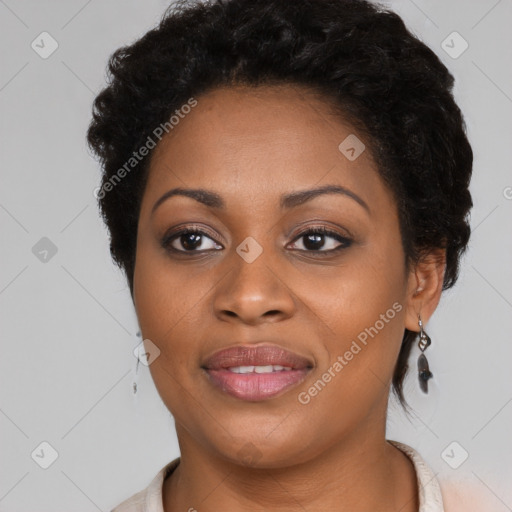 Joyful black adult female with medium  brown hair and brown eyes