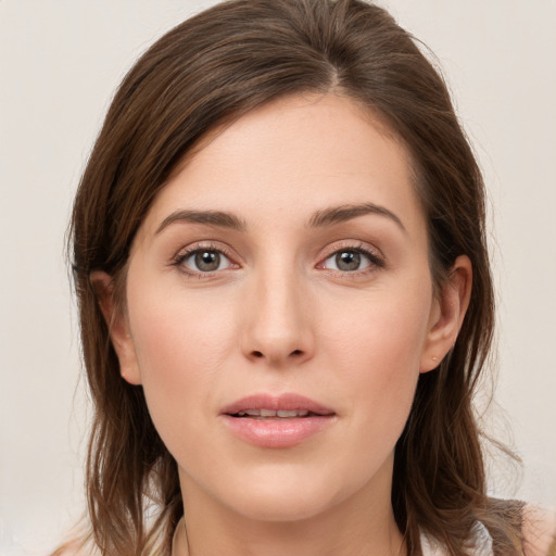 Joyful white young-adult female with long  brown hair and green eyes