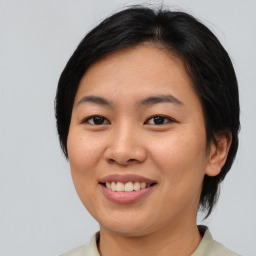 Joyful asian young-adult female with medium  black hair and brown eyes