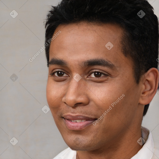 Joyful black young-adult male with short  black hair and brown eyes